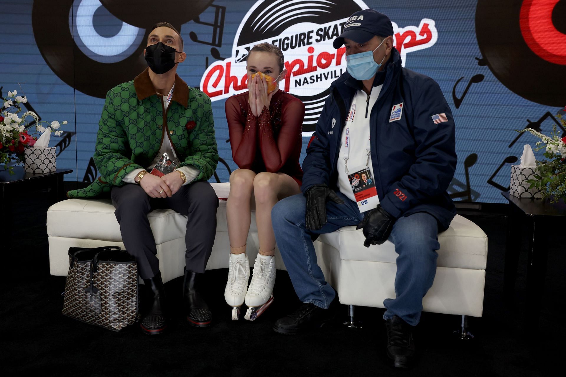 Mariah Bell waits with coaches Adam Rippon and Rafael Arutyunyan for her scores after skating in the Ladies Free Skate during the U.S. Figure Skating Championships